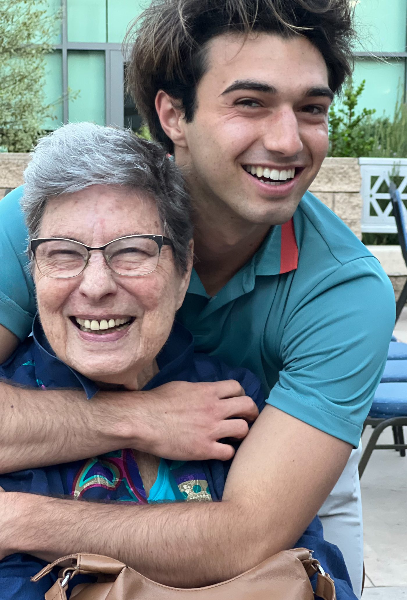 A mother and her son embracing and smiling